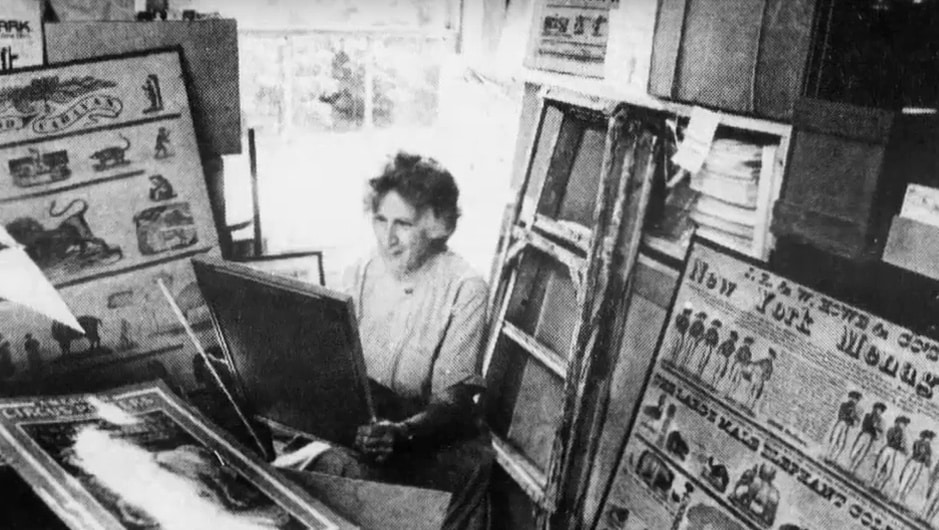 (There are hardly any photos of Mabel Addis. Here she is examining historic circus panels for her museum in 1984.)